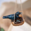 Miniature Handmade Carrion Crow made from polymer clay sat on a nest with realistic replica eggs