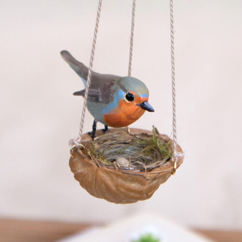 handmade robin sculpture on walnut nest